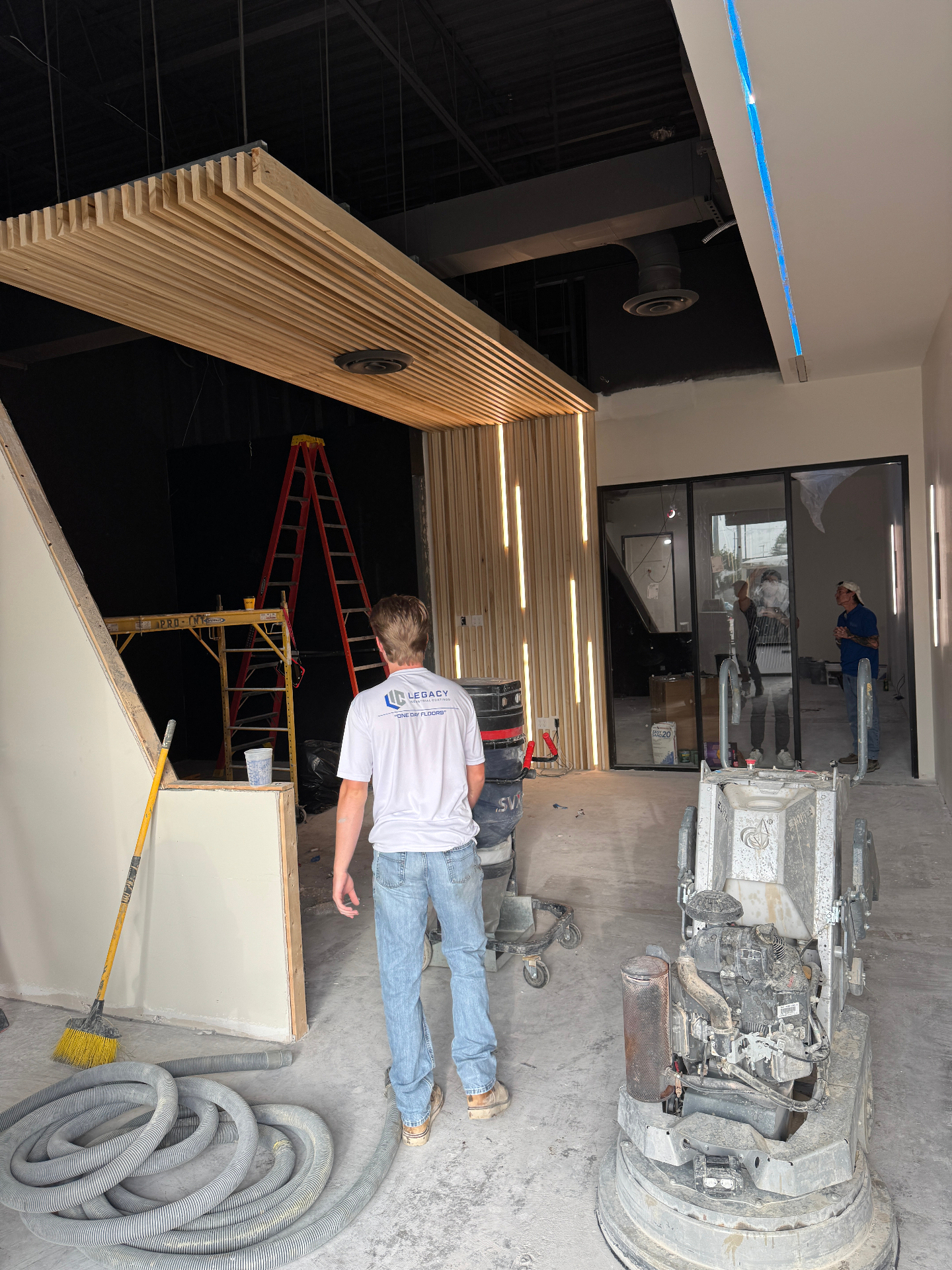 Legacy Industrial Coatings crew member preparing a commercial concrete slab for resin flooring in DFW